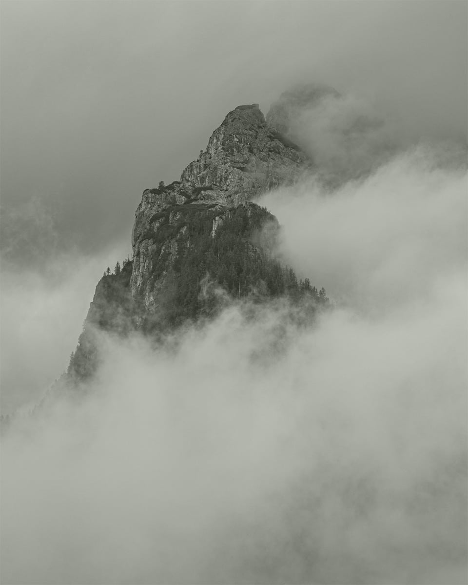 Clouds surrounding a mountainous peak